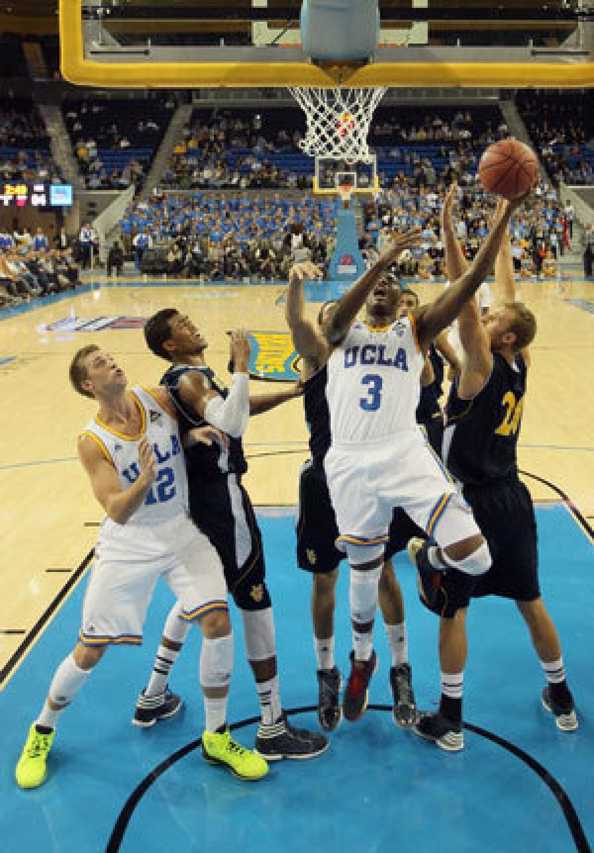 Jordan Adams of UCLA puts back a rebound against UC Irvine.