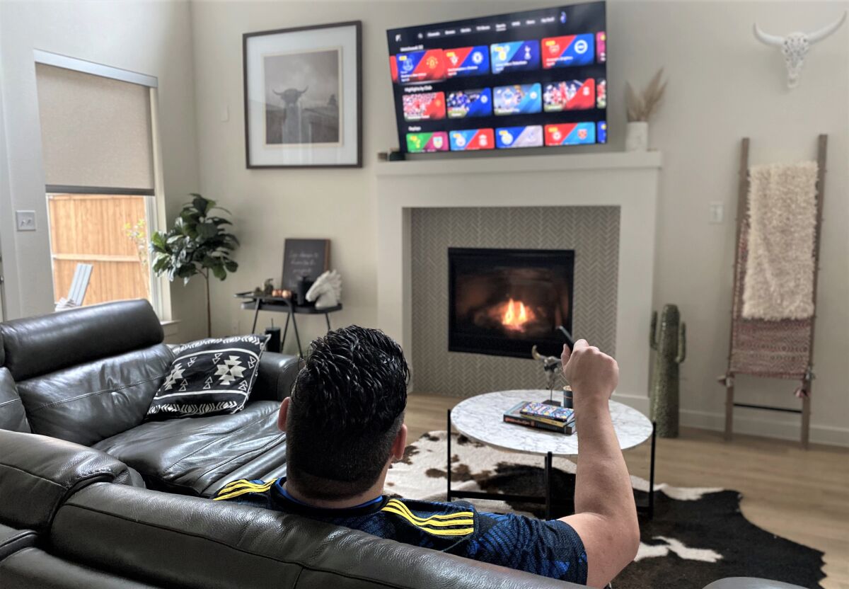 Eric Vieira checks out the streaming options on his smart TV.