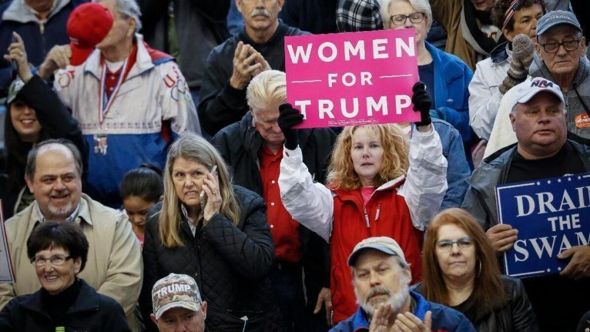 A supporter of President Trump holds a sign at a rally in Lebanon, Ohio, on Oct. 12.