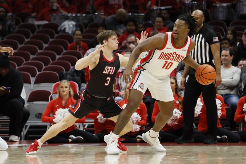 Ohio State's Brice Sensabaugh, right, posts up against Saint Francis' Luke Ruggery during the first half of an NCAA college basketball game on Saturday, Dec. 3, 2022, in Columbus, Ohio. (AP Photo/Jay LaPrete)