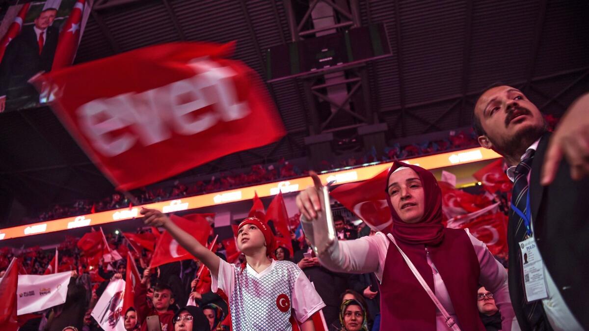 Supporters wave Turkey's national flags and a flag reading "Yes" in Turkish during a campaign rally in Istanbul.
