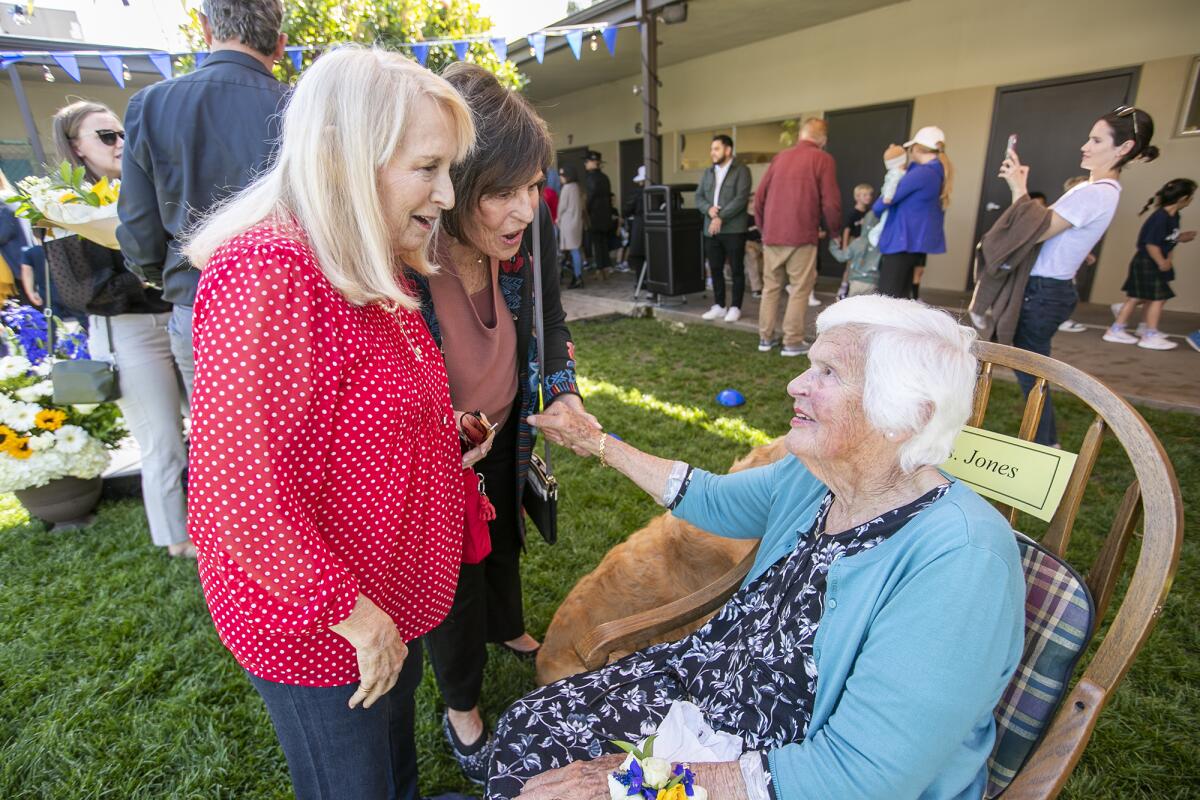 Elizabeth Purcell, left, and Kay Hurwitz, center, both former first-grade teachers, greet Jane Jones.