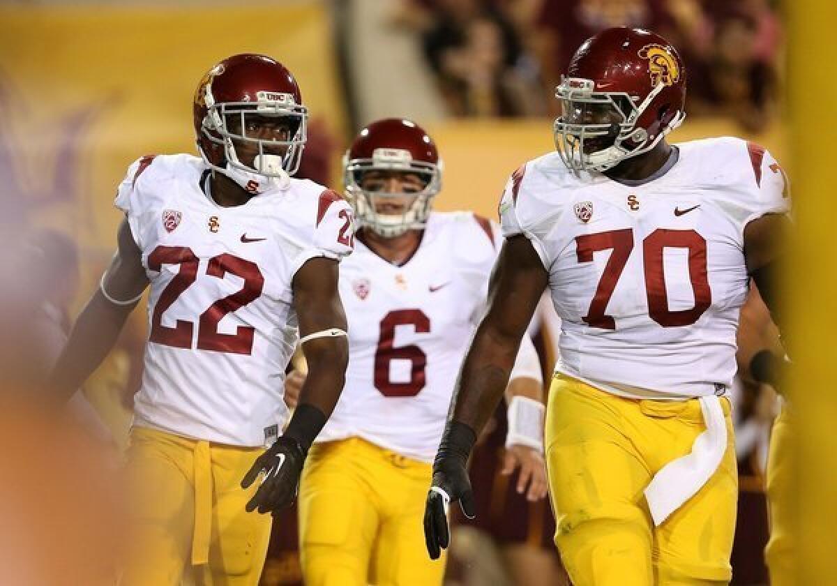 USC running back Justin Davis, quarterback Cody Kessler and offensive tackle Aundrey Walker exit the field after Davis' 26-yard touchdown run against Arizona State.