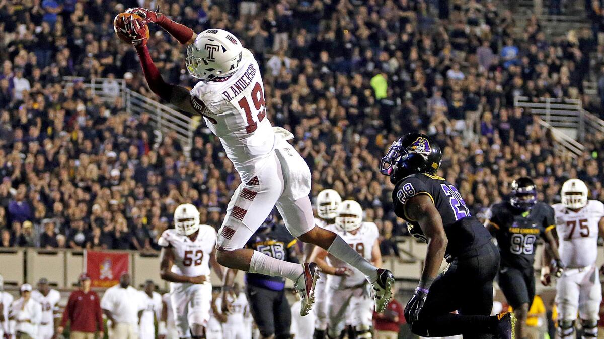 Temple receiver Robby Anderson hauls in the go-ahead touchdown pass in front of East Carolina's Josh Hawkins (28).