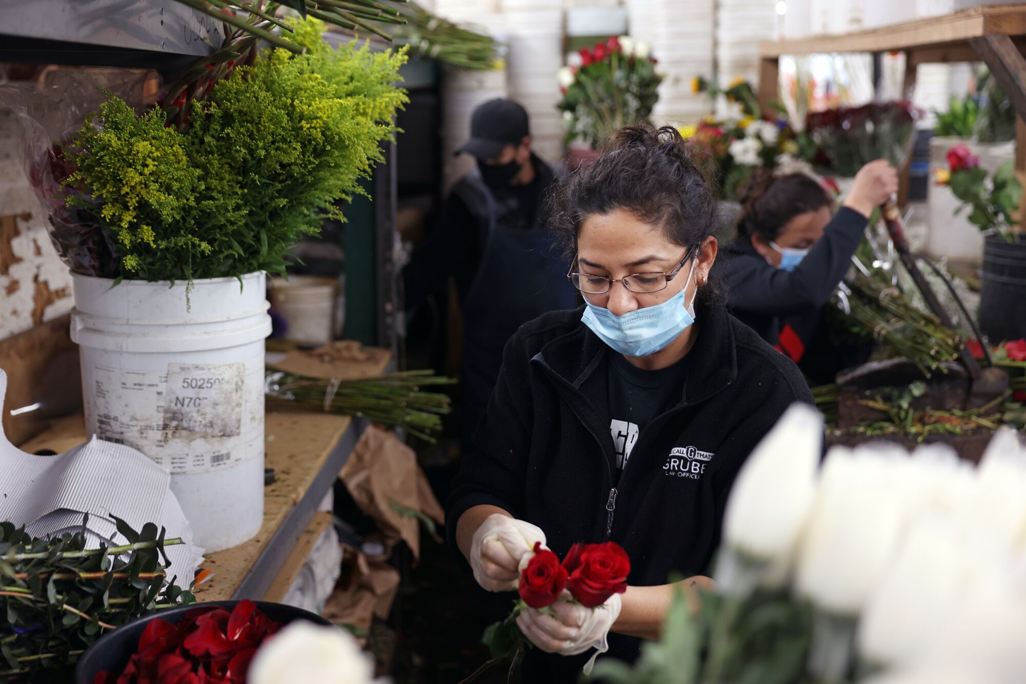 Esmeralda Sanchez prepares roses at Julia's Wholesale Flowers.