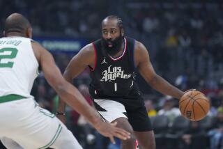 Los Angeles Clippers guard James Harden (1) dribbles against Boston Celtics center Al Horford, left, during the first half of an NBA basketball game in Los Angeles, Saturday, Dec. 23, 2023. (AP Photo/Eric Thayer)