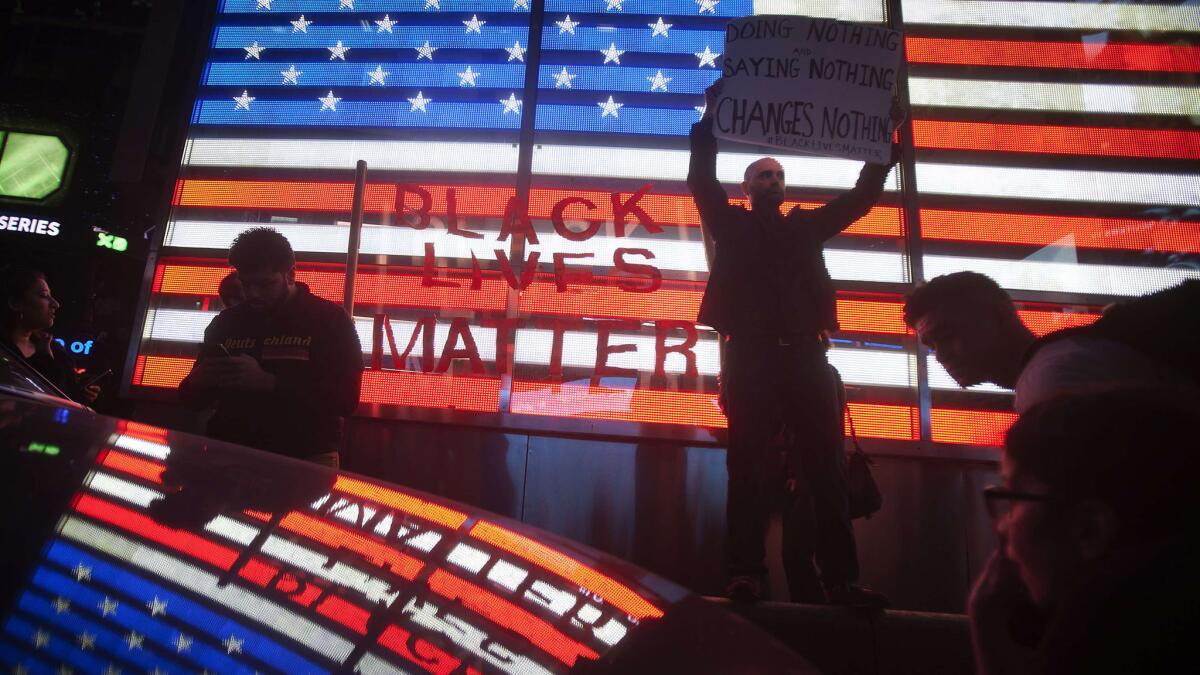 Protesters demonstrate in New York's Times Square after the grand jury's decision to not charge Ferguson police officer Darren Wilson in the shooting death of unarmed 18-year-old Michael Brown was announced.