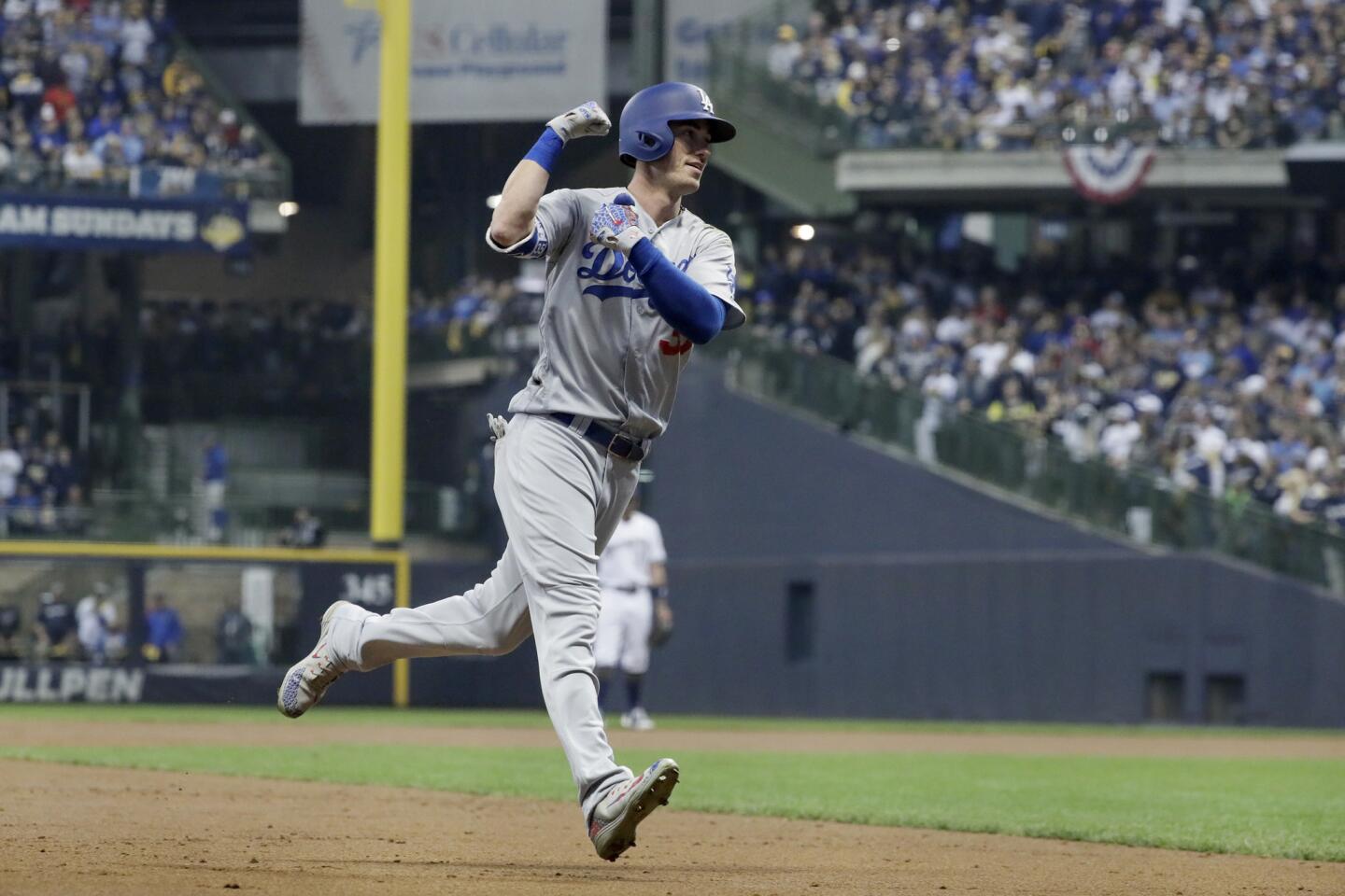 Cody Bellinger flexes his muscle as he rounds the bases on a second inning, two run homer.