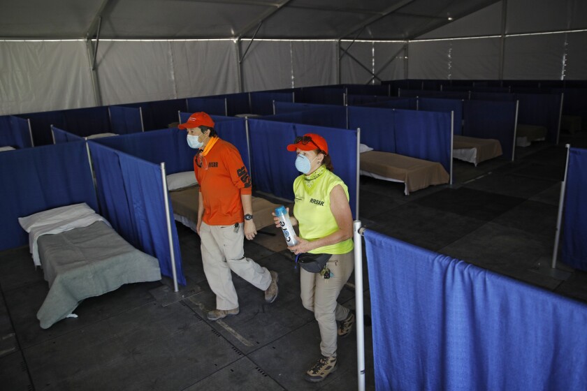 Members of the Red Rock Search and Rescue help set up a coronavirus isolation and quarantine complex in Las Vegas.