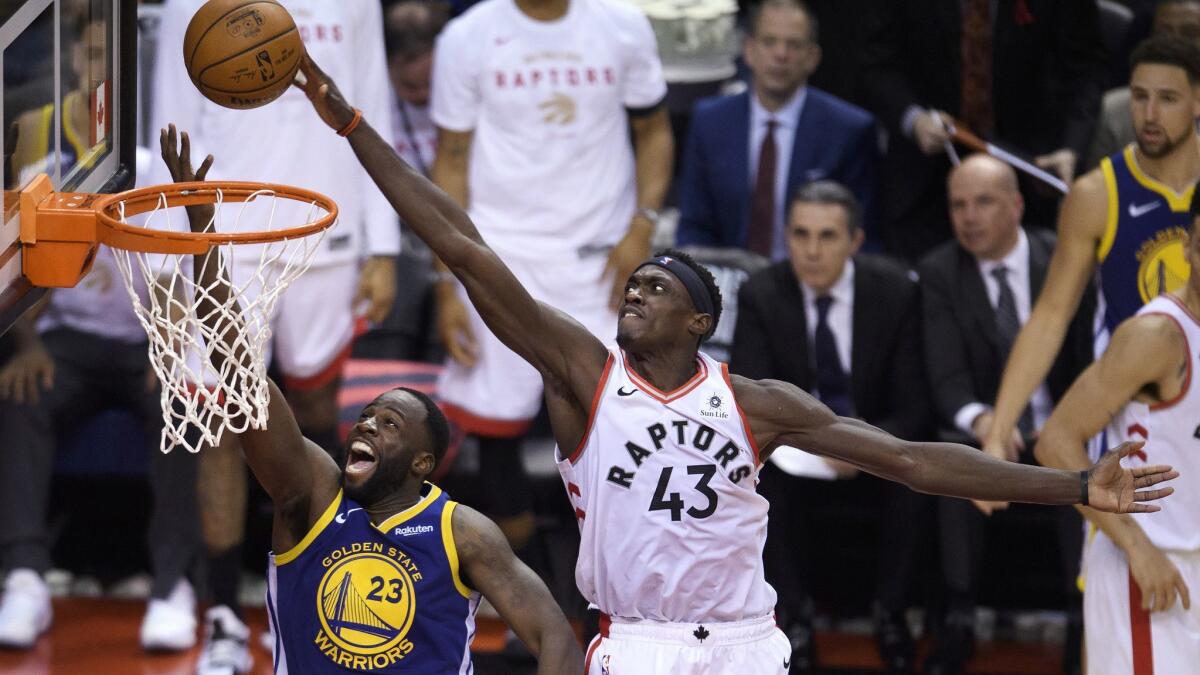 Toronto Raptors forward Pascal Siakam (43) blocks a shot by Golden State Warriors forward Draymond Green (23) during the second half of Game 1 of the NBA Finals on Thursday in Toronto.