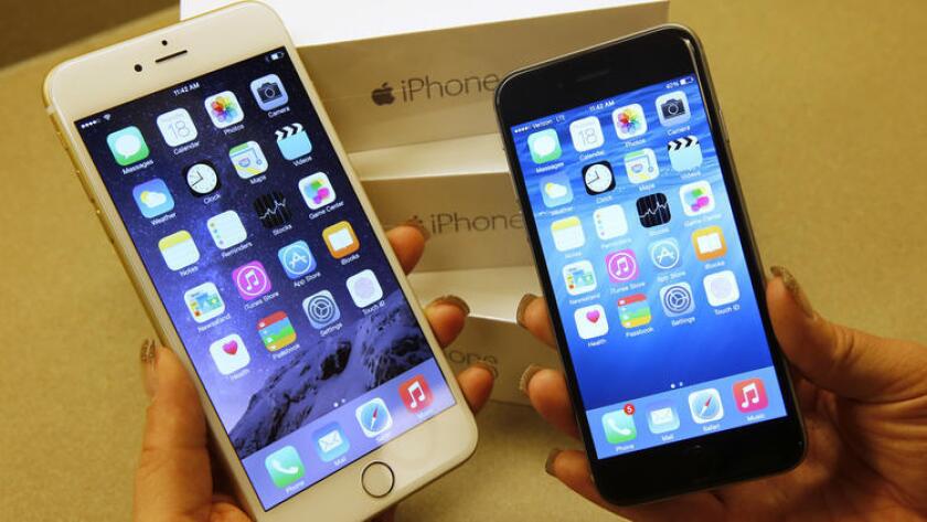 Apple's iPhone 6, right, and iPhone 6 Plus are shown at a Verizon store in Utah.