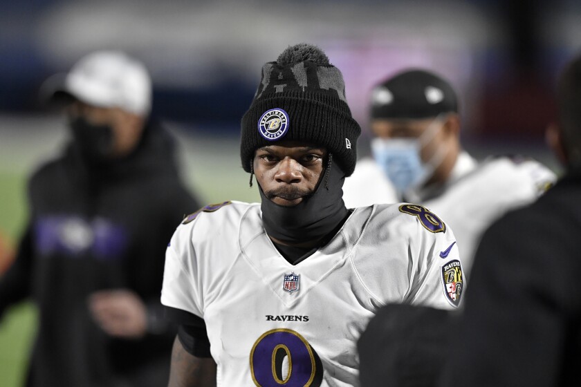 FILE - Baltimore Ravens quarterback Lamar Jackson (8) leaves the field after the first half of an NFL divisional round football game against the Buffalo Bills in Orchard Park, N,Y., in this Saturday, Jan. 16, 2021, file photo. Ravens general manager Eric DeCosta has already started making some of the tough decisions he believes can help Baltimore negotiate the leap from playoff qualifier to Super Bowl champion. After releasing running back Mark Ingram and quarterback Robert Griffin III last week, DeCosta announced Monday, Jan. 25, 2020, that the Ravens won't re-sign All-Pro long snapper Morgan Cox, the initial component of the highly successful placekicking trio that includes holder Sam Koch and second-team All-Pro Justin Tucker, the most accurate field goal kicker in NFL history.(AP Photo/Adrian Kraus, File)