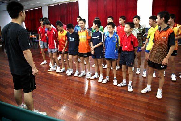 Li Zhuoming, 10, of Harbin, second from right in the front row, begins his pingpong training with other boys at a sports school in Beijing.