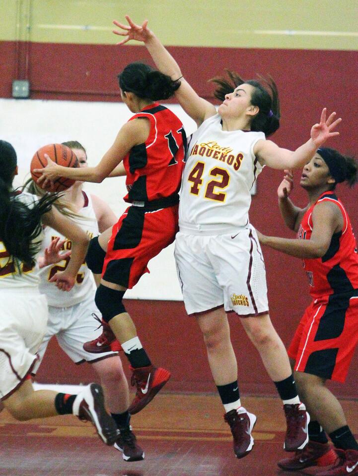 GCC's Jessica Sanchez (42) reaches to attempt to block the shot of Imperial Valley College's Vanessa Villareal in a women's basketball game at GCC on Friday, January 3, 2014. (Tim Berger/Staff Photographer)