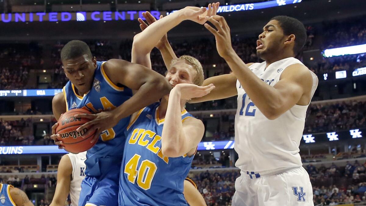 UCLA forward Kevon Looney battles, left, for a rebound next to his teammate Thomas Welsh, center, and Kentucky forward Karl-Anthony Towns during the Bruins' blowout loss in Chicago on Dec. 20.