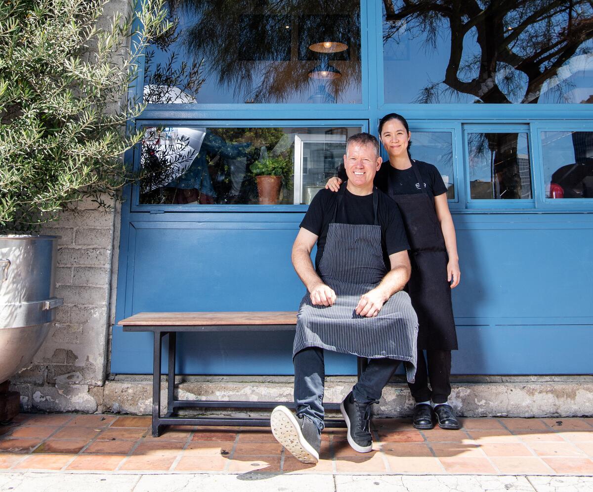 Chefs Walter, sitting, and Margarita Manzke, standing, pictured outside of République.