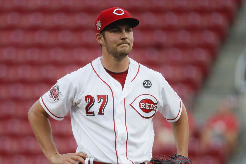 FILE - In this Aug. 19, 2019 file photo Cincinnati Reds starting pitcher Trevor Bauer reacts.