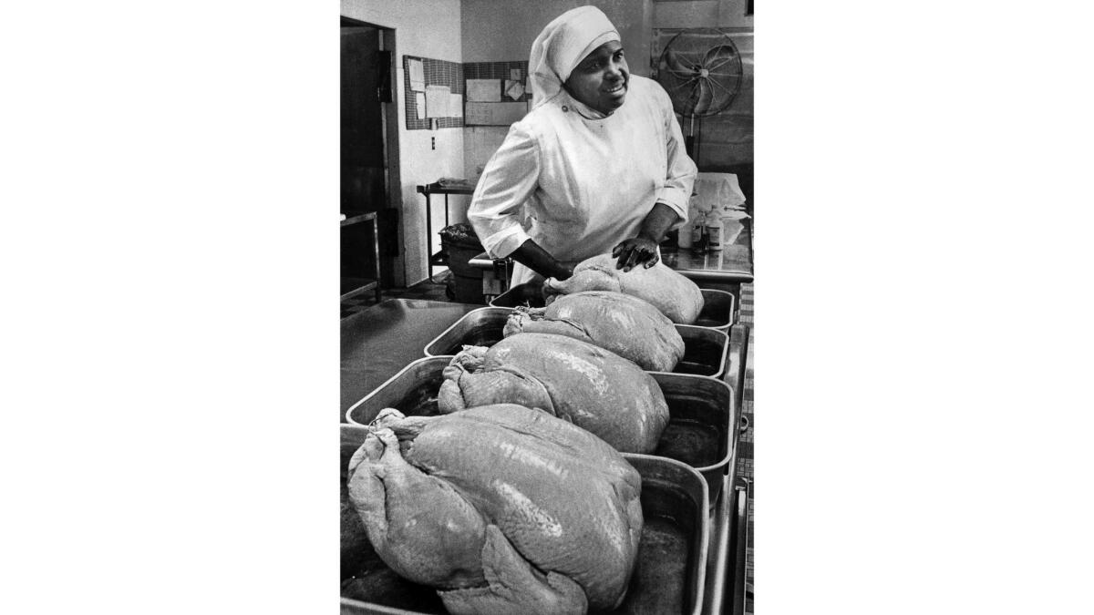 Nov. 24, 1976: Sister Benedict, chief cook at St. Ann's Home for the Aged in East Los Angeles, prepares four donated turkeys for Thanksgiving dinner.