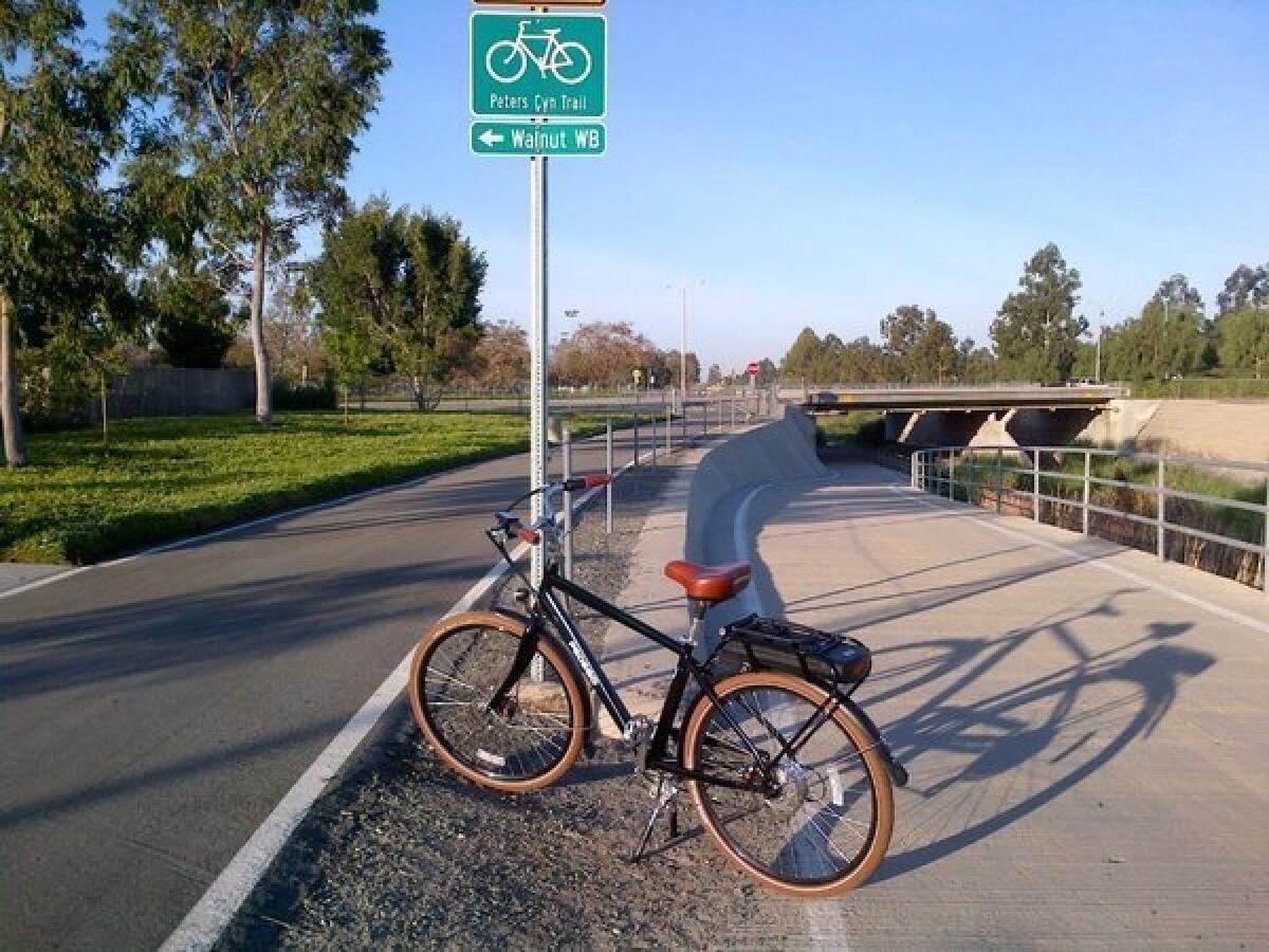 L.A. Times editor Peter Pae's Pedego City Commuter electric bicycle on a bike path in Irvine.