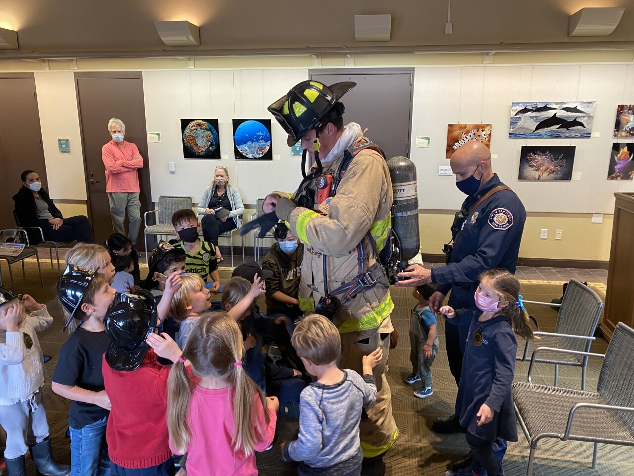 Young La Jolla/Riford Library guests get an up-close look at a firefighter's suit and equipment.