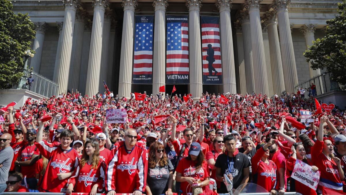 Fans gather on the steps of the National Archives as they wait to watch the Washington Capitals' Stanley Cup victory parade.