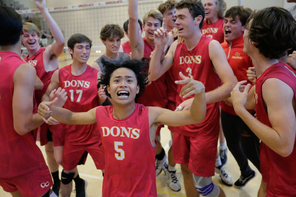 Zach Talampas and rest of the Cathedral Catholic boys volleyball team celebrate the Open Division title.
