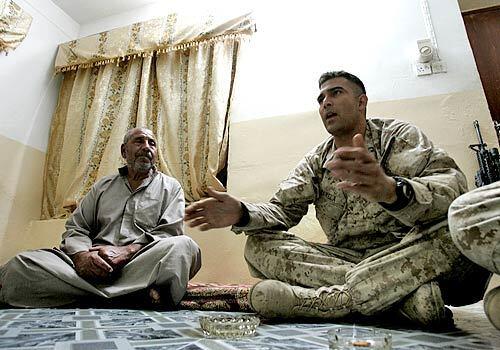 PEACEFUL MISSION: Capt. Max Barela talks with residents as part of a counterinsurgency census operation in Ramadi, Iraq.