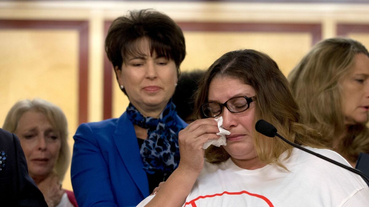 Norma Hernandez, backed by state Sen. Connie Leyva (D-Chino), wipes her eyes as she talks at a September 2016 news conference about being raped when she was 13. Leyva sponsored a bill that ended California's statute of limitation in some rape cases. (Rich Pedroncelli / Associated Press)