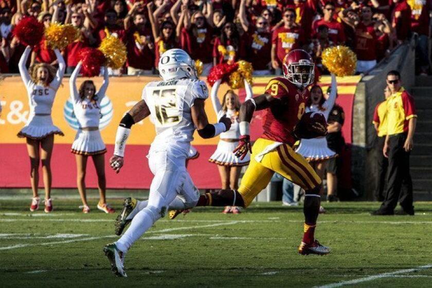 Trojans receiver Marqise Lee beats Ducks defensive back Brian Jackson to the end zone for a touchdown in the first half Saturday.