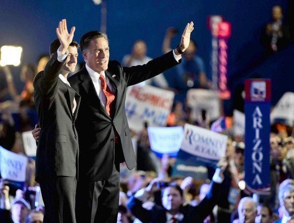 Paul Ryan, left, and Mitt Romney wave to supporters at the Republican National Convention in Tampa, Fla., in August 2012. 