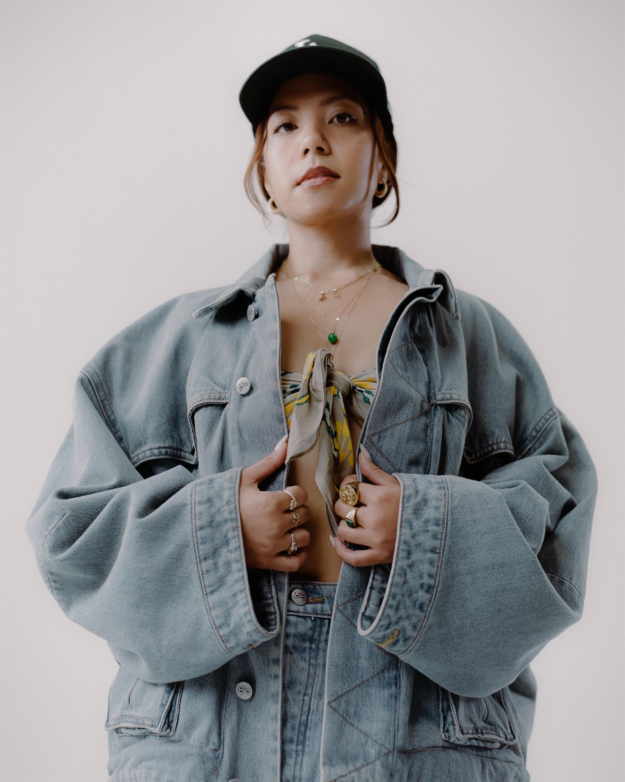 Stephanie wears Art Community Washed Reversible 7 Pocket Japanese Denim overgarment and Washed Indigo Triptych Japanese pants