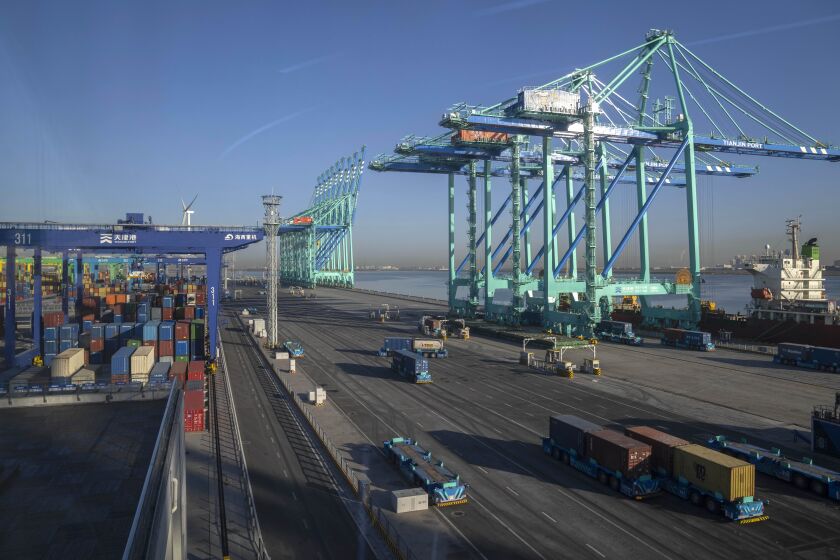 Driverless trucks move shipping containers at an automated port in Tianjin, China, Monday, Jan. 16, 2023. China's exports fell 7.5% from a year ago in May, 2023, and imports were down 4.5%, adding to signs an economic recovery is slowing. (AP Photo/Mark Schiefelbein)