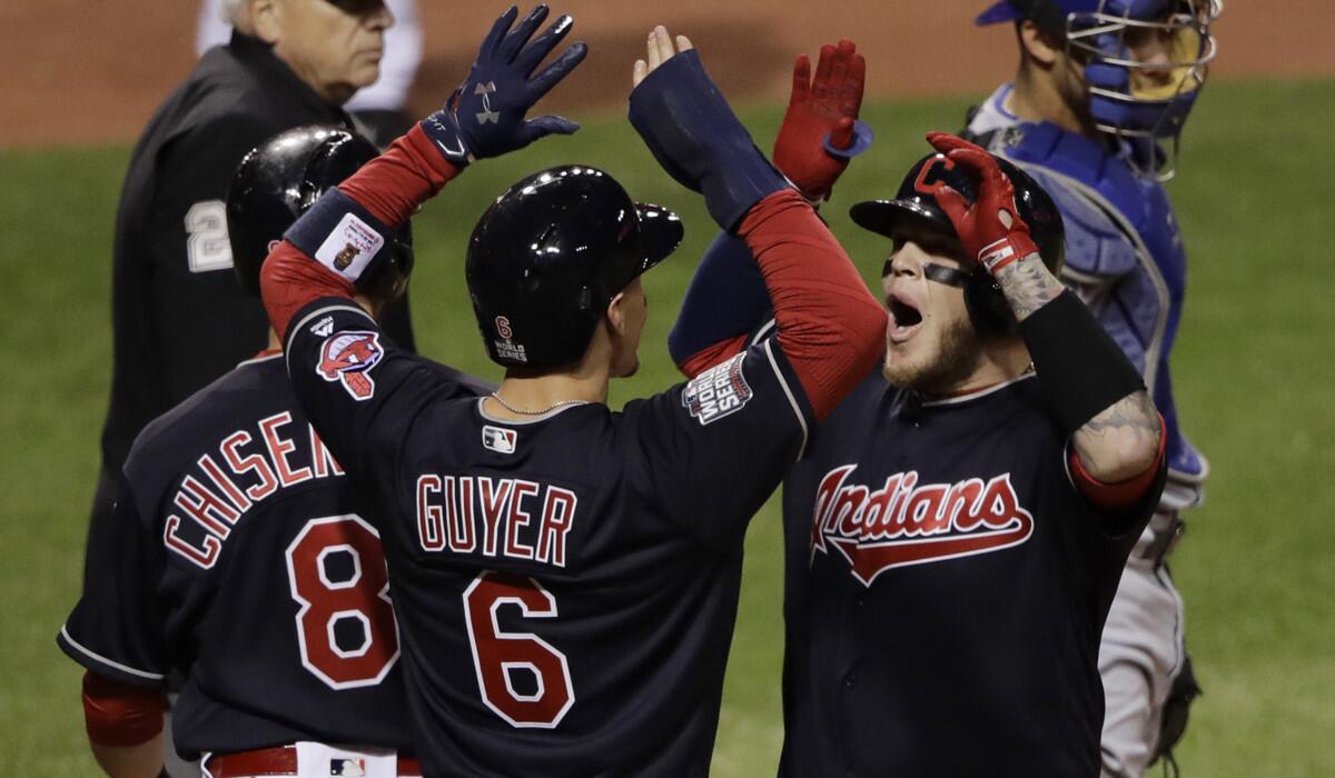 The Cleveland Indians' Roberto Perez, left, celebrates with Brandon Guyer (6) and Lonnie Chisenhall (8) after hitting a three-run home run during the eighth inning against the Chicago Cubs in Game 1 of the World Series on Oct. 25.