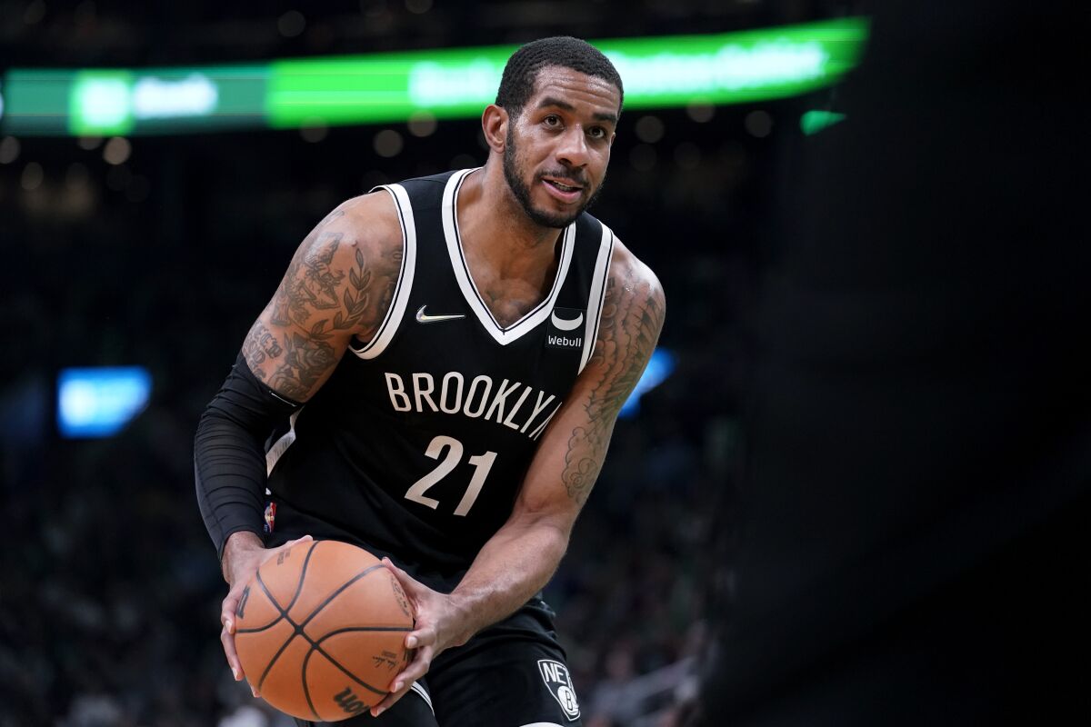 FILE -Brooklyn Nets center LaMarcus Aldridge (21) plays in the second half of an NBA basketball game against the Boston Celtics, Sunday, March 6, 2022, in Boston. LaMarcus Aldridge has announced he is retiring again from the NBA. The 37-year-old initially retired in 2021 after experiencing an irregular heartbeat in the last of five games he played for the Brooklyn Nets that season. He rejoined the Nets five months after announcing his retirement.(AP Photo/Steven Senne, File)