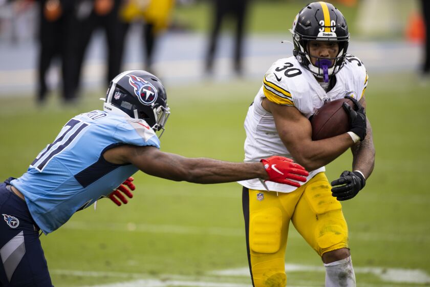 Tennessee Titans free safety Kevin Byard (31) reaches for Pittsburgh Steelers running back James Conner (30) as Conner carries the ball during the second half of an NFL football game, Sunday, Oct. 25, 2020, in Nashville, Tenn. (AP Photo/Brett Carlsen)
