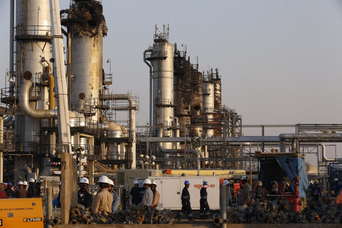 Workers fix the damage in Aramco's oil separator at a processing facility after the Sept. 14 attack in Saudi Arabia's eastern province.