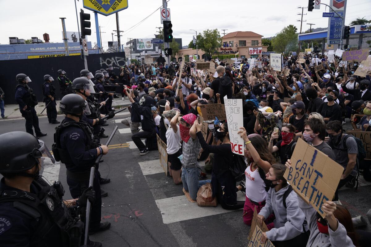 People protest at Pan Pacific Park in Los Angeles. 