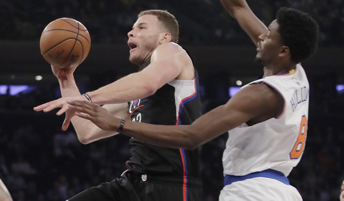 Clippers' Blake Griffin (32) drives past New York Knicks' Justin Holiday (8) during the first half Wednesday.