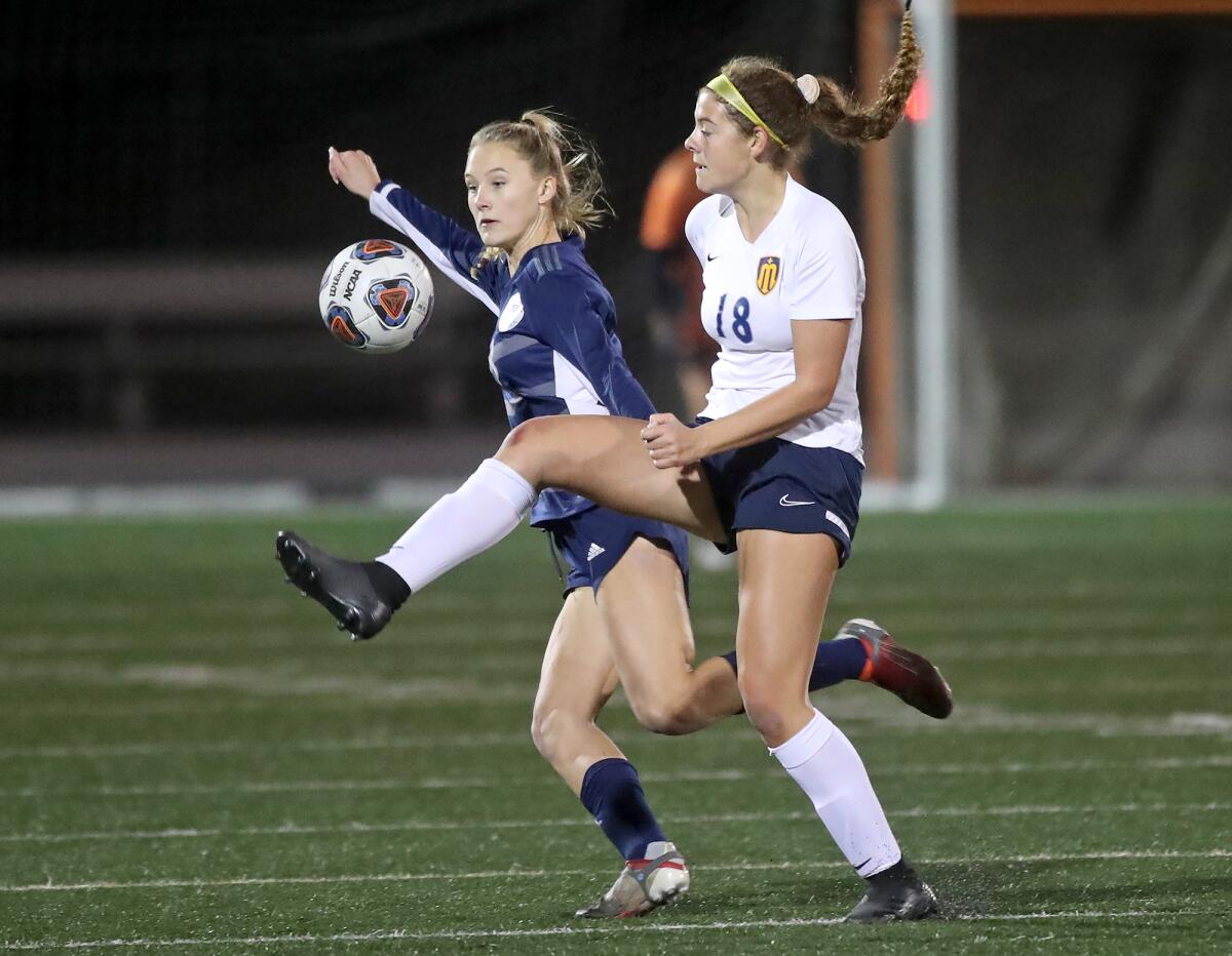 Marina's Abby Kirby (18) passes the ball during a Wave League girls' soccer game against Newport Harbor on Tuesday.