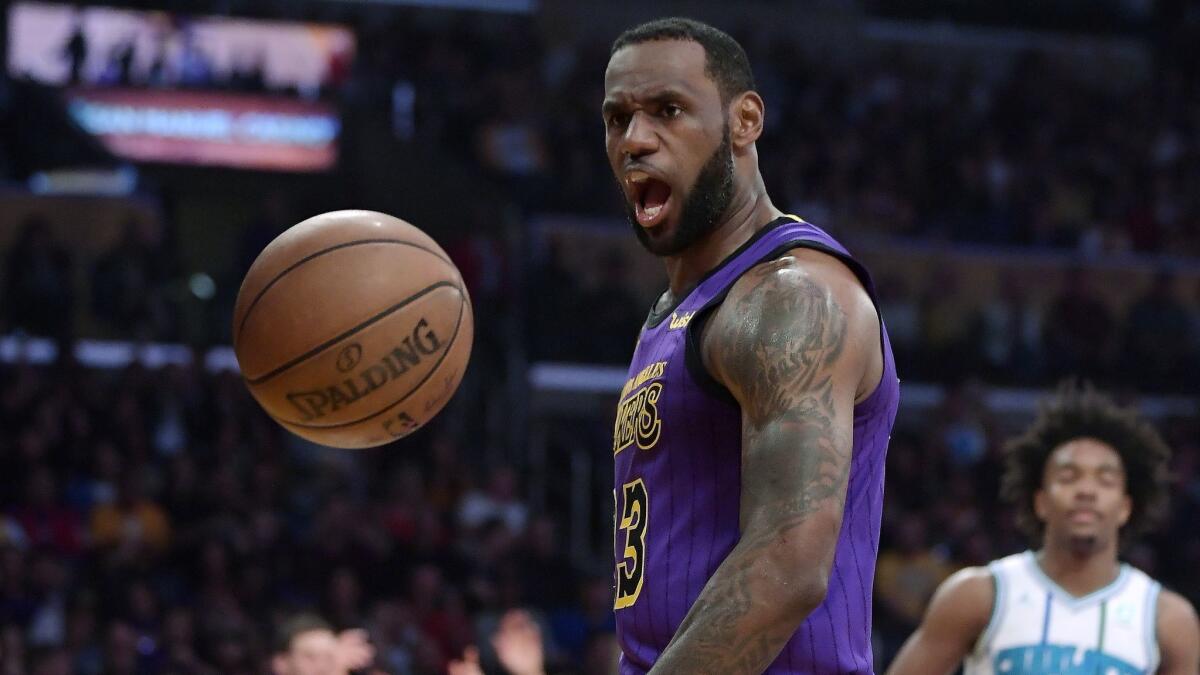 Lakers star LeBron James yells after dunking during a 129-115 victory over the Charlotte Hornets on Friday.