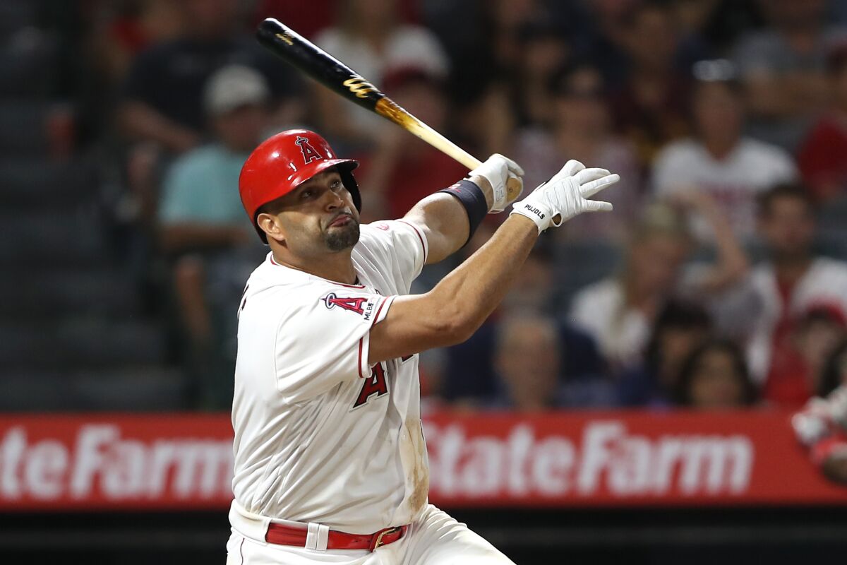 The Angels' Albert Pujols hits a three-run homer in a 10-4 win over the Red Sox on Aug. 31, 2019.
