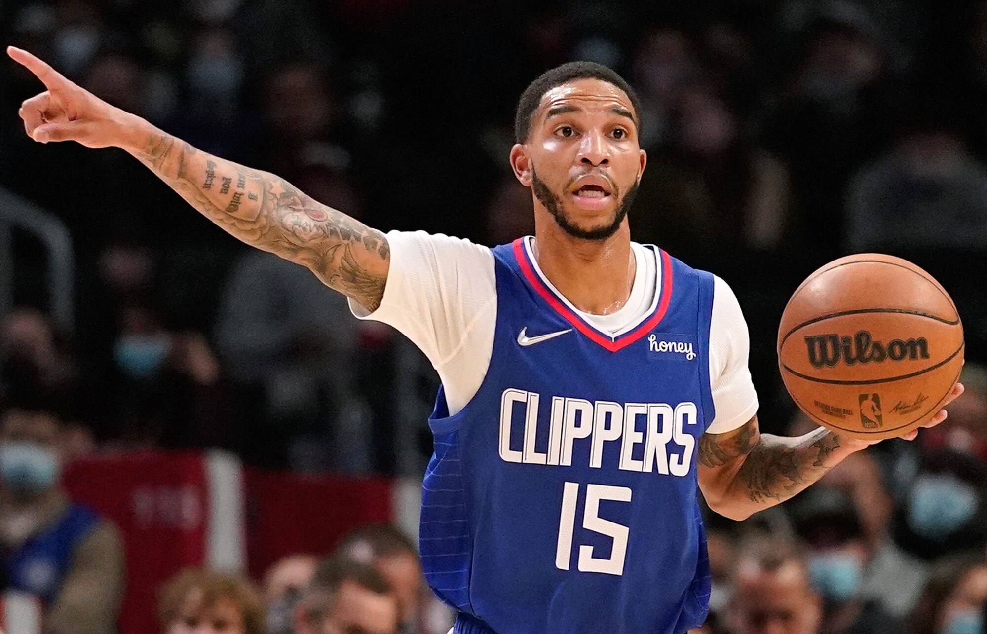 Clippers guard Xavier Moon points to his right as he brings the ball up court.