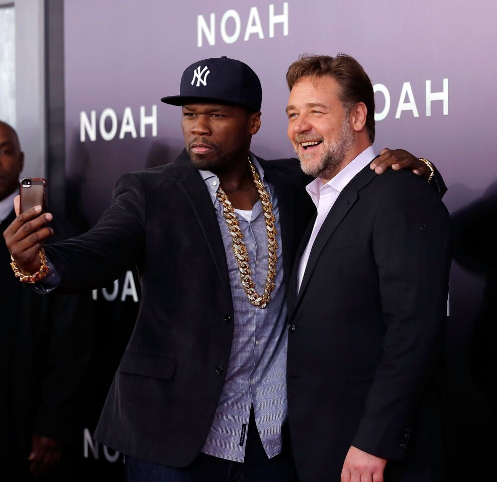 Rapper Curtis "50 Cent" Jackson, left, and actor Russell Crowe take a selfie during the New York premiere of "Noah" at Clearview Ziegfeld Theatre on March 26, 2014, in New York City.