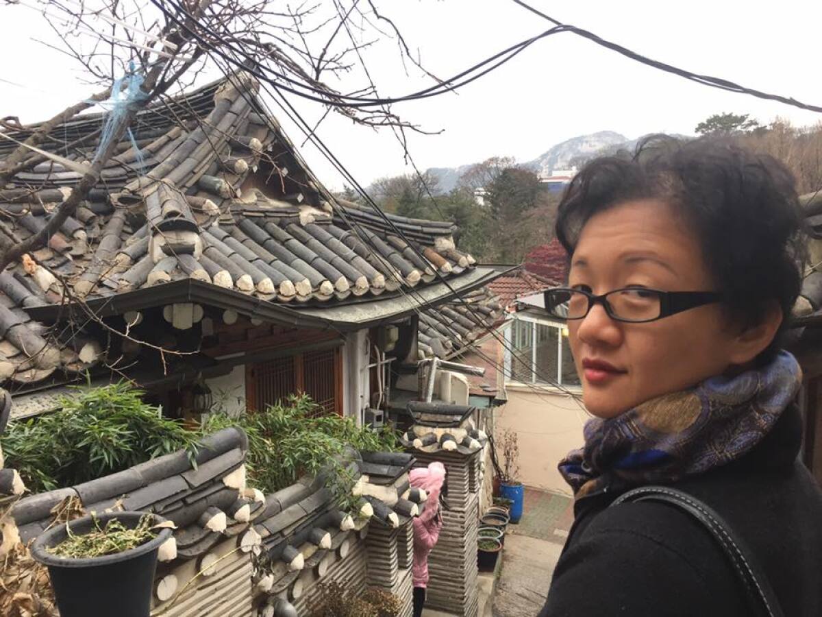 Julie Macartney visits Seoul, old temple in background.