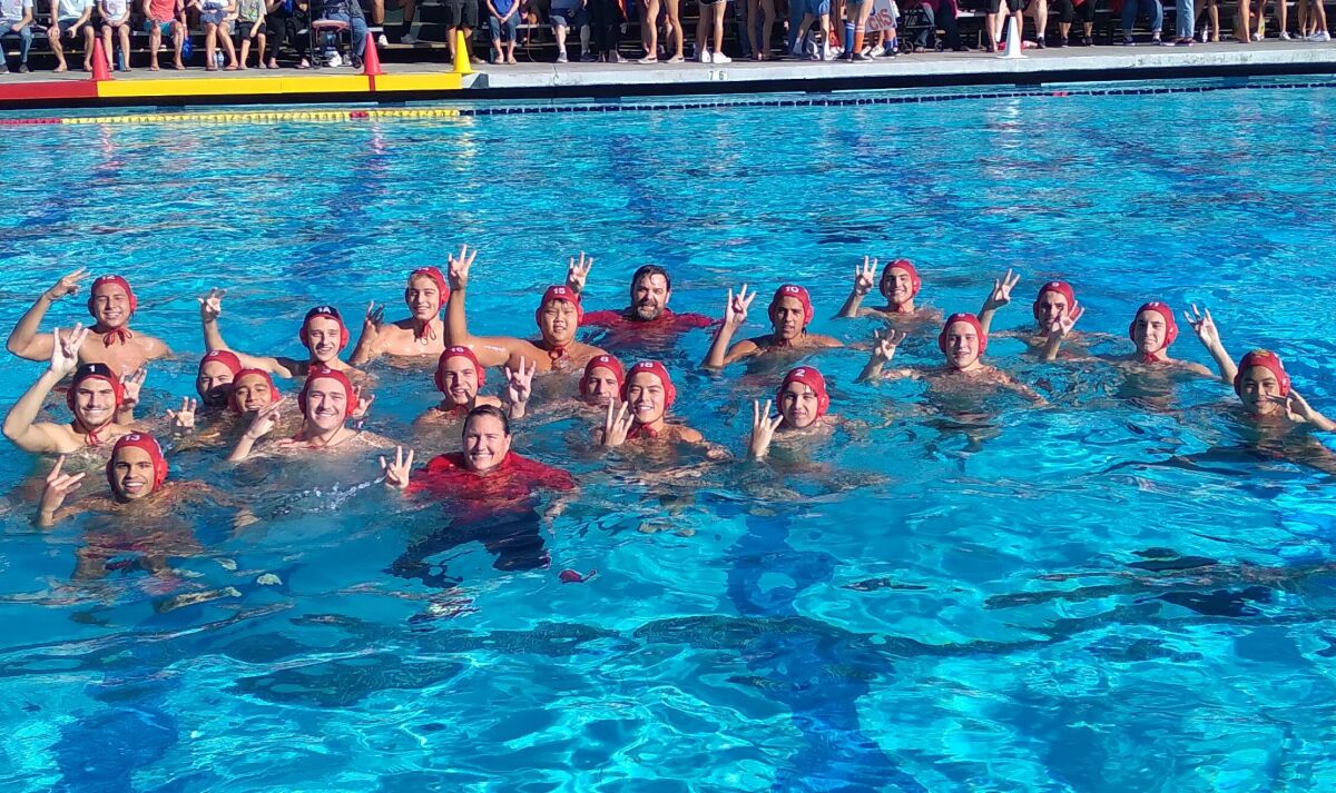 The Mt. Carmel High boys water polo team celebrates winning the San Diego Section Division II boys water polo championship.
