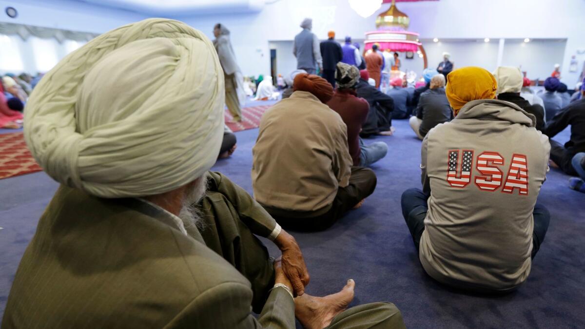 Men attend Sunday services at a Sikh temple in Renton, Wash.