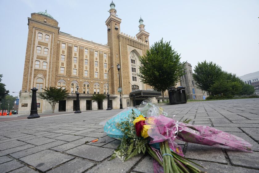 Flowers are placed in front of the Altria Theater which was the site of a mass shooting after a graduation ceremony Wednesday, June 7, 2023, in Richmond, Va. (AP Photo/Steve Helber)