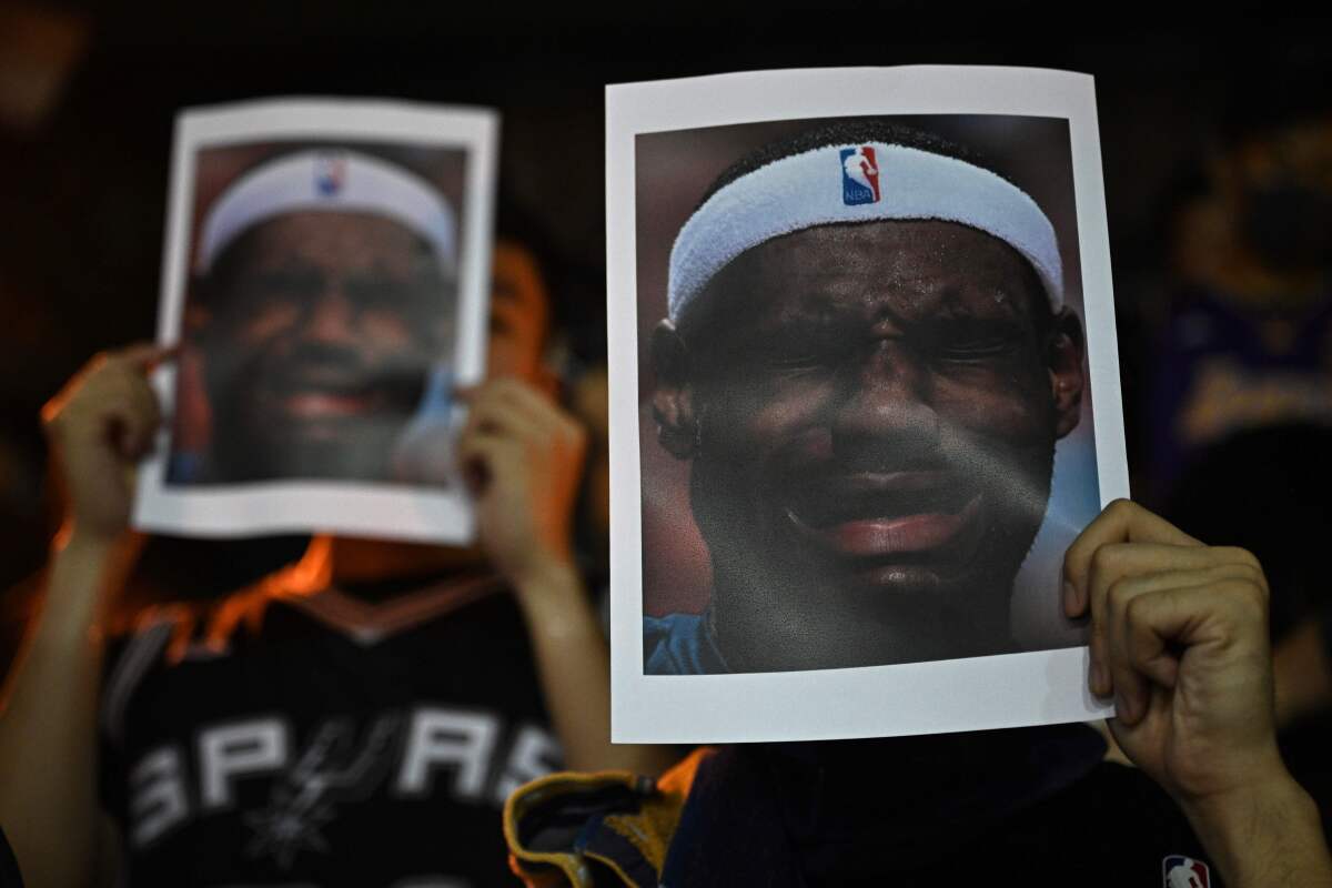 Protesters in Hong Kong hold photographs Lakers star LeBron James during a rally on Tuesday.