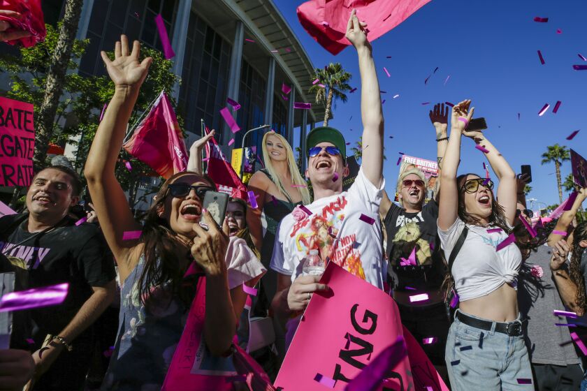 Los Angeles, CA - November 12: Free Britney supporters celebrate after hearing a Los Angeles Superior Court judge today formally has ended the conservatorship that has controlled Britney Spears' life for nearly 14 years outside Stanley Mosk Courthouse on Friday, Nov. 12, 2021 in Los Angeles, CA. (Irfan Khan / Los Angeles Times)
