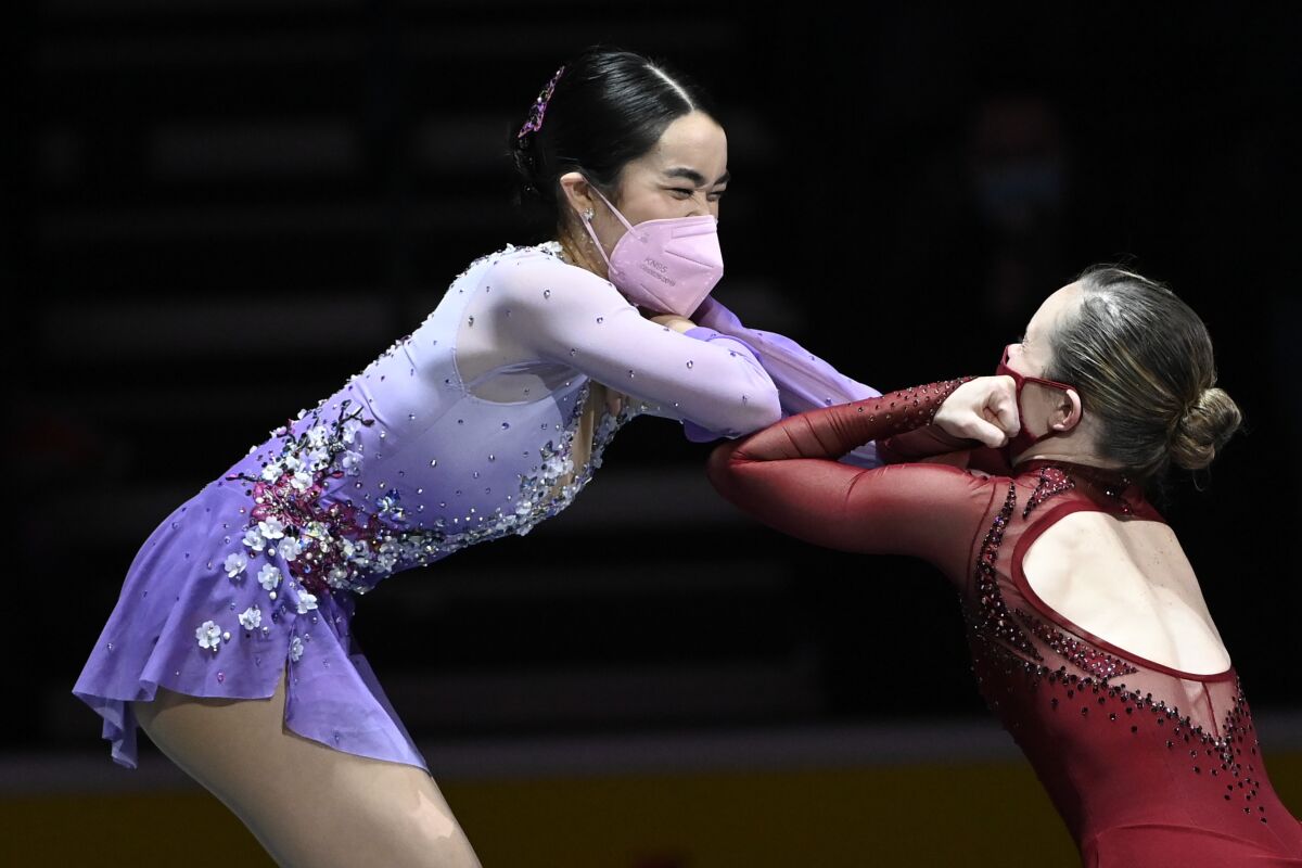 Karen Chen touches Mariah Bell's elbows with her own.